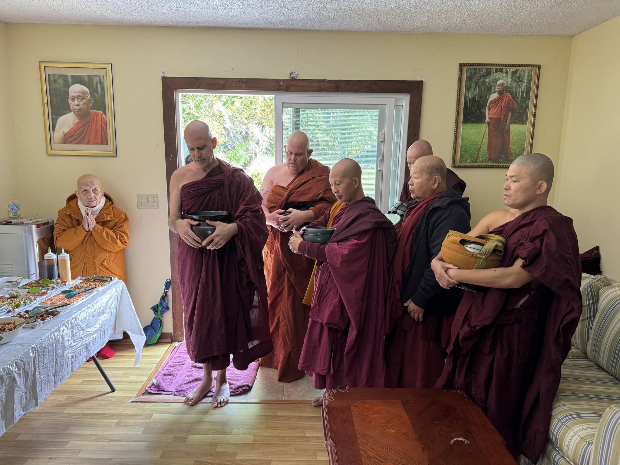 Visitors offering food to monks